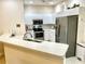 Clean white kitchen with stainless steel appliances and ample counter space at 1431 Red Oak Ln, Port Charlotte, FL 33948