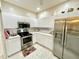 Bright kitchen featuring stainless steel appliances and ample cabinet space at 1431 Red Oak Ln, Port Charlotte, FL 33948