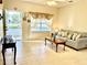 Inviting living room with comfortable seating, tile flooring, and bright, airy ambiance at 1431 Red Oak Ln, Port Charlotte, FL 33948
