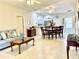 Open-concept living and dining area with tile flooring, ceiling fans, and lots of natural light at 1431 Red Oak Ln, Port Charlotte, FL 33948