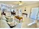 Open-concept living room featuring tile floors, ceiling fans, and an inviting seating arrangement at 1431 Red Oak Ln, Port Charlotte, FL 33948
