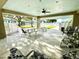 An outdoor patio offers covered seating with tables, chairs and open views of the community at 1431 Red Oak Ln, Port Charlotte, FL 33948