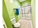 Shower with glass doors, tiled walls, and grab bars for added safety at 1431 Red Oak Ln, Port Charlotte, FL 33948