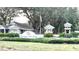 Entrance to Heritage Oak Park showing the community sign, landscaping, and an American flag at 1431 Red Oak Ln, Port Charlotte, FL 33948