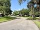 Picturesque street showcasing well-maintained lawns, mature trees, and beautiful homes at 1431 Red Oak Ln, Port Charlotte, FL 33948