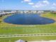 Scenic aerial view showcasing a well-maintained golf course and lake in a beautiful community at 15039 Black Cherry Way, Punta Gorda, FL 33955