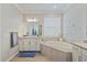 Bright bathroom with a soaking tub, double vanity, and tile flooring at 15039 Black Cherry Way, Punta Gorda, FL 33955