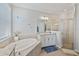 A luxurious bathroom featuring a soaking tub and a glass-enclosed shower at 15039 Black Cherry Way, Punta Gorda, FL 33955