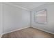 An empty bedroom with hardwood floors and a window to provide natural light at 15039 Black Cherry Way, Punta Gorda, FL 33955