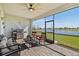 Outdoor patio featuring a grill, seating, and a scenic view of the lake and surrounding landscape at 15039 Black Cherry Way, Punta Gorda, FL 33955