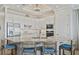 Eat-in kitchen with modern appliances, an island with bar seating, and white cabinetry at 15039 Black Cherry Way, Punta Gorda, FL 33955