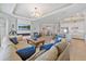 Spacious living room featuring a fireplace, large TV, and modern chandelier at 15039 Black Cherry Way, Punta Gorda, FL 33955