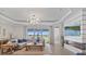 Open-plan living area with water views, fireplace, and modern lighting at 15039 Black Cherry Way, Punta Gorda, FL 33955