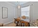 A home office with a large wooden desk, a chair, and a window at 15039 Black Cherry Way, Punta Gorda, FL 33955