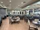 Open-concept restaurant area, featuring multiple tables and chairs, a full bar, and big-screen TVs at 15039 Black Cherry Way, Punta Gorda, FL 33955