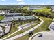 Aerial view of immaculate tennis and bocce ball courts, surrounded by mature trees and landscaping at 15039 Black Cherry Way, Punta Gorda, FL 33955