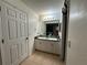 Functional bathroom featuring a double sink vanity, a large mirror, and tile flooring at 1609 Log Ln, North Port, FL 34286
