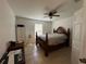 Bedroom featuring neutral walls, tile floors, ceiling fan, and a window at 1609 Log Ln, North Port, FL 34286