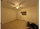 Bedroom featuring painted walls, tile floors, boarded up window, and a ceiling fan at 1609 Log Ln, North Port, FL 34286