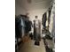 Walk-in closet featuring hanging racks, a safe, and tile flooring at 1609 Log Ln, North Port, FL 34286
