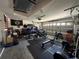 Garage featuring workout equipment and motorized vehicles at 1609 Log Ln, North Port, FL 34286