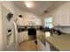 Efficient kitchen with white cabinets, stainless steel appliances, and a functional layout at 1609 Log Ln, North Port, FL 34286