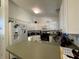 Functional kitchen featuring white cabinets, stainless steel appliances, and a convenient breakfast bar at 1609 Log Ln, North Port, FL 34286