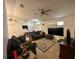 Cozy living room featuring tile floors, neutral walls, ceiling fan and a comfortable seating arrangement at 1609 Log Ln, North Port, FL 34286