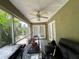 Screened outdoor patio featuring a tiled floor and partial view of backyard at 1609 Log Ln, North Port, FL 34286