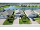 Aerial view of the home featuring a well-manicured yard and neighborhood pond at 16824 Canopy Garden Dr, Port Charlotte, FL 33953