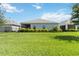 Spacious backyard with a line of manicured bushes at 16824 Canopy Garden Dr, Port Charlotte, FL 33953