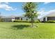 Picture of a lush backyard with lawn and trees, providing a relaxing retreat at 16824 Canopy Garden Dr, Port Charlotte, FL 33953