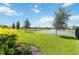 Lush backyard featuring a serene pond view at 16824 Canopy Garden Dr, Port Charlotte, FL 33953