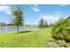 Backyard overlooking a serene pond, perfect for outdoor enjoyment at 16824 Canopy Garden Dr, Port Charlotte, FL 33953