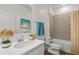 Clean bathroom with a single sink vanity, framed mirror, and a tiled shower and tub at 16824 Canopy Garden Dr, Port Charlotte, FL 33953