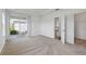 Bright bedroom with a sliding glass door, neutral carpet, and a walk-in closet at 16824 Canopy Garden Dr, Port Charlotte, FL 33953