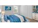 Nautical themed bedroom with blue bedding, white dresser, and a sunlit window at 16824 Canopy Garden Dr, Port Charlotte, FL 33953