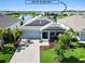 Charming single-story home featuring a two-car garage and covered front porch in a lakeside community at 16824 Canopy Garden Dr, Port Charlotte, FL 33953