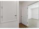 Hallway with wood-look tile floor and a storage closet near a door leading to another room at 16824 Canopy Garden Dr, Port Charlotte, FL 33953