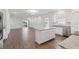 Well-lit kitchen with a center island, stainless steel appliances, and sliding glass doors at 16824 Canopy Garden Dr, Port Charlotte, FL 33953