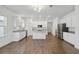 Spacious open-concept kitchen featuring stainless steel appliances, a center island, and wood-look floors at 16824 Canopy Garden Dr, Port Charlotte, FL 33953
