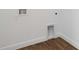 Interior laundry hookups near the floor with tiled flooring and neutral colored walls at 16824 Canopy Garden Dr, Port Charlotte, FL 33953