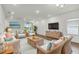 Bright living room with comfortable seating and a TV at 16824 Canopy Garden Dr, Port Charlotte, FL 33953