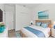 Cozy main bedroom featuring a queen size bed, nautical decor, and a large closet at 16824 Canopy Garden Dr, Port Charlotte, FL 33953