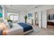 Comfortable bedroom with a sliding glass door, stylish decor, and an ensuite bathroom at 16824 Canopy Garden Dr, Port Charlotte, FL 33953