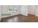 Office space with wood floors, natural light, and glass-panel door at 16824 Canopy Garden Dr, Port Charlotte, FL 33953