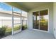 Covered patio with screened enclosure, perfect for enjoying the outdoors at 16824 Canopy Garden Dr, Port Charlotte, FL 33953
