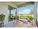 Covered patio with lake views and seating area perfect for outdoor entertaining at 16824 Canopy Garden Dr, Port Charlotte, FL 33953