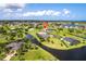 Expansive aerial view of a waterfront home in a lush community near the ocean and waterfront canals at 17150 Sarong Ln, Punta Gorda, FL 33955