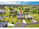 Expansive aerial view showcases the home's prime waterfront location, lush landscaping, and community setting at 17150 Sarong Ln, Punta Gorda, FL 33955
